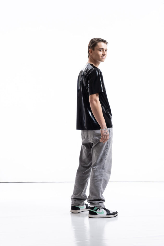 Black latex oversized shirt for men with relaxed silhouette, side view