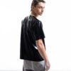 Black latex oversized shirt for men with relaxed silhouette, side detail view