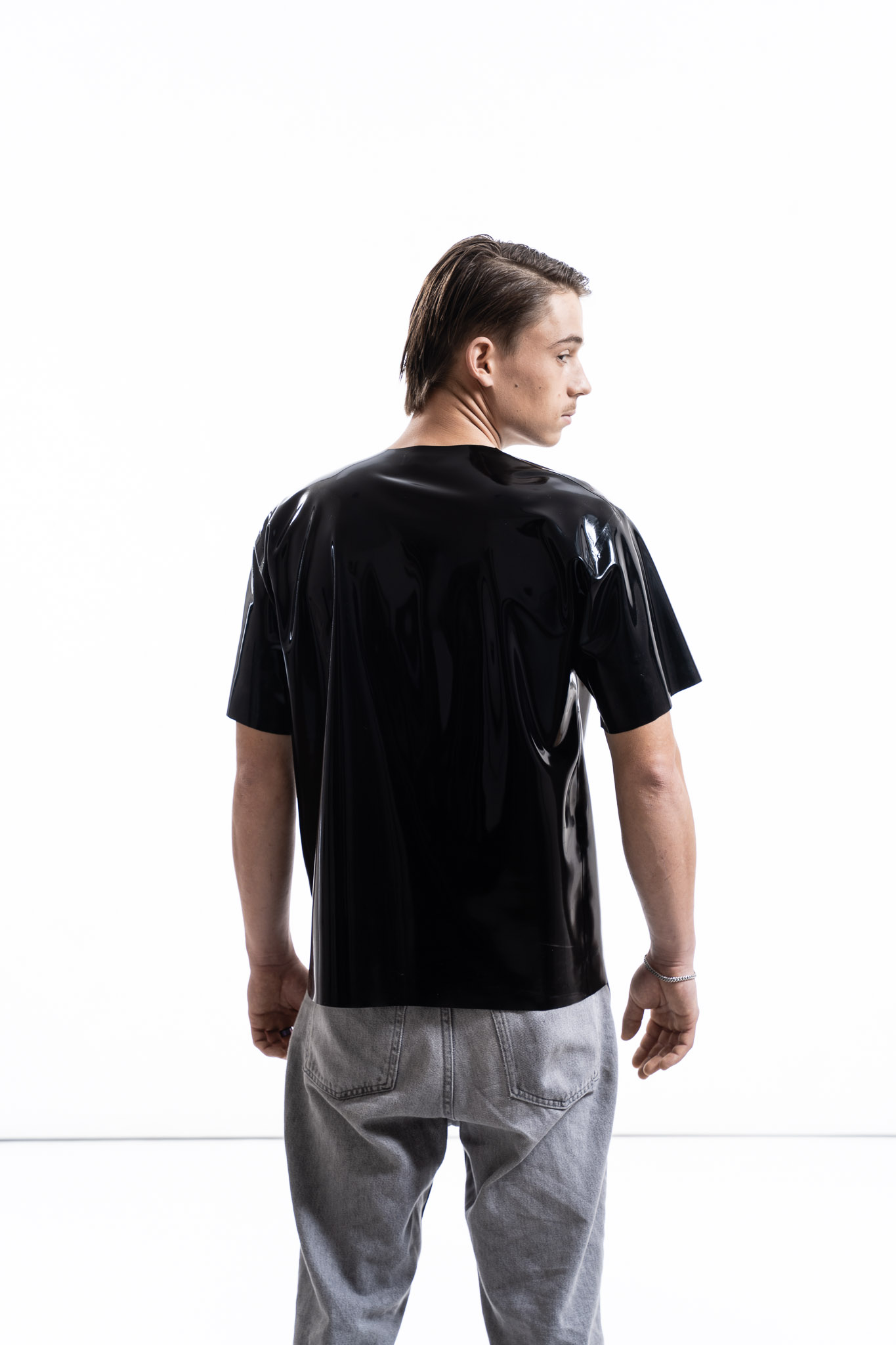 Black latex oversized shirt for men with relaxed silhouette, back detail view