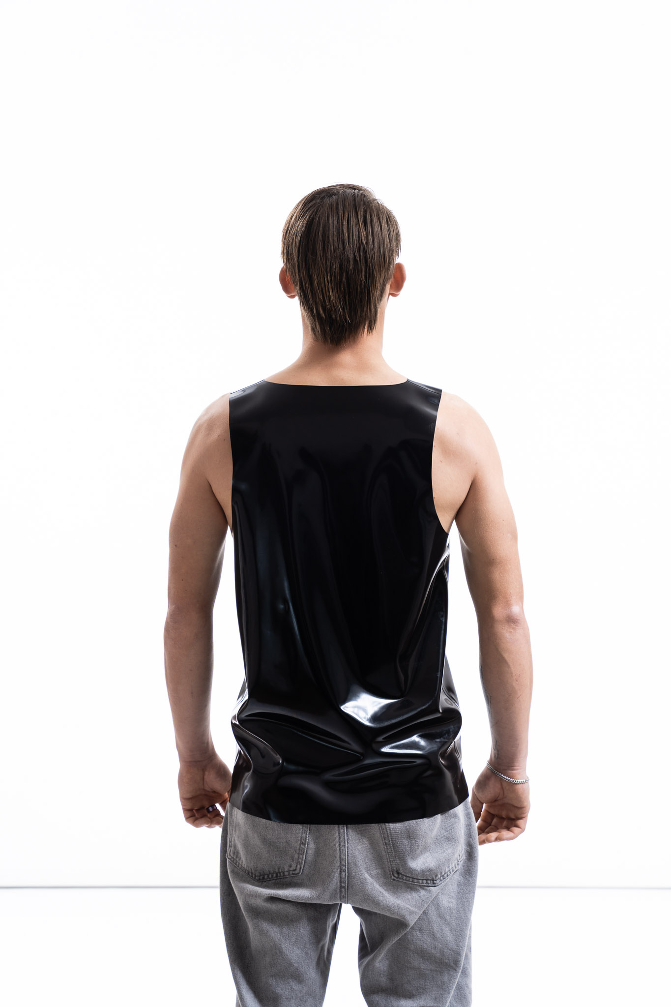 Black latex tank top for men with relaxed silhouette, back detail view
