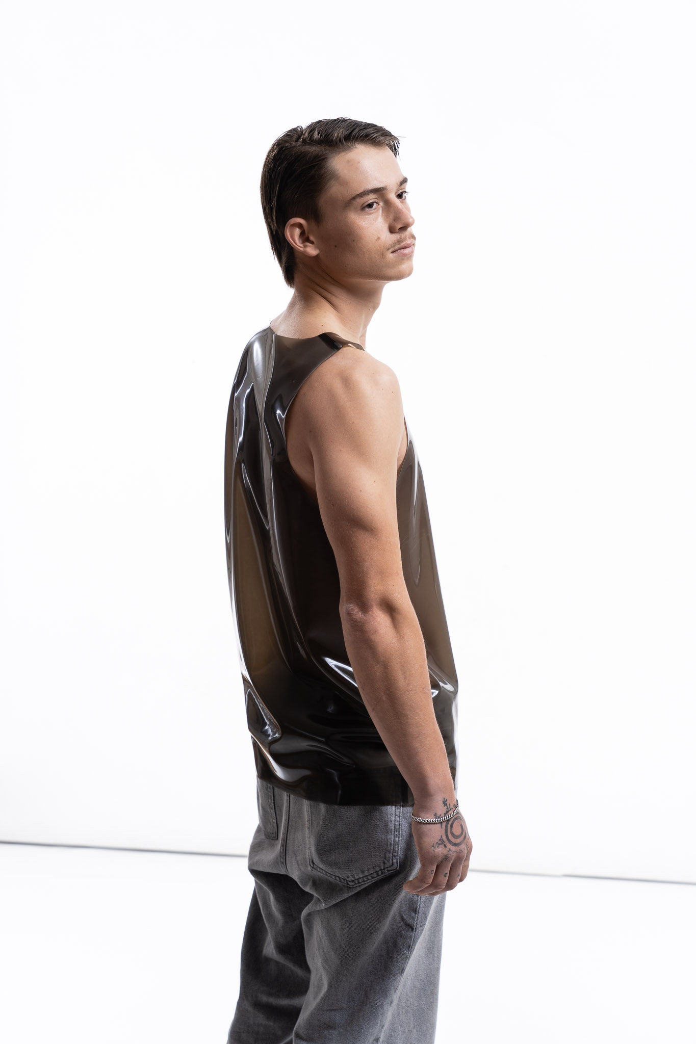 Smoky black latex tank top for men with clean fitted silhouette, side detail view